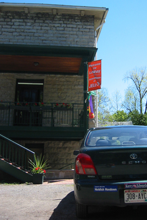 Car with Hotdish Hoedown sticker parked in front of Jell-O Gallery in LeRoy, New York.